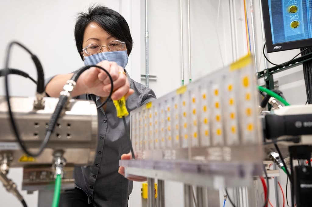 Scientist adjusting instrumentation on a laboratory sample rack